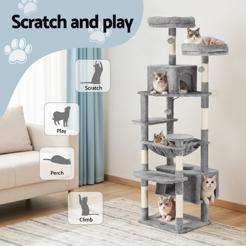 Cat tree with multiple levels and cats on a living room floor, featuring text 'Scratch and play'.