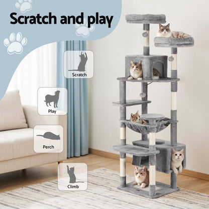 Cat tree with multiple levels and cats on a living room floor, featuring text 'Scratch and play'.